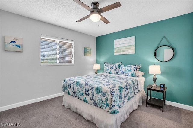 carpeted bedroom with ceiling fan and a textured ceiling