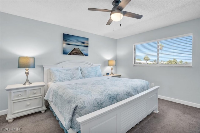 bedroom featuring ceiling fan, a textured ceiling, and carpet