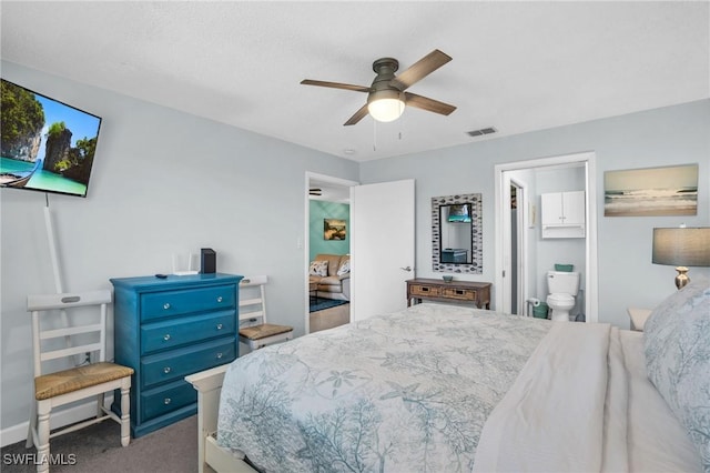 bedroom with ceiling fan, ensuite bath, and carpet flooring