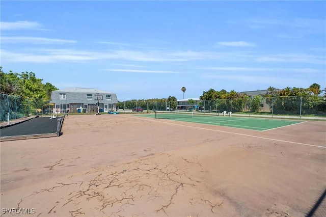 view of property's community featuring tennis court