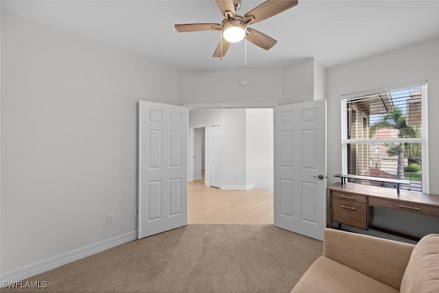 interior space with ceiling fan and light carpet