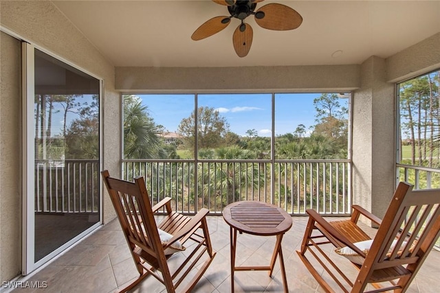 sunroom featuring ceiling fan