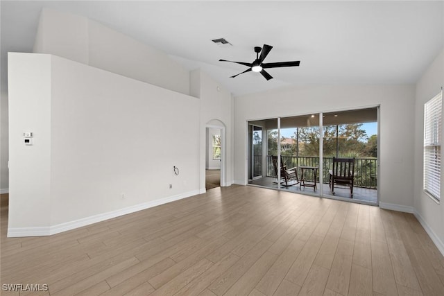 empty room featuring ceiling fan, lofted ceiling, and light wood-type flooring