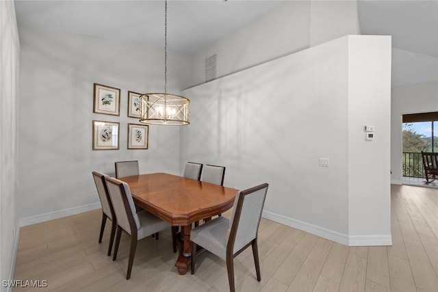 dining room featuring a notable chandelier and light hardwood / wood-style floors