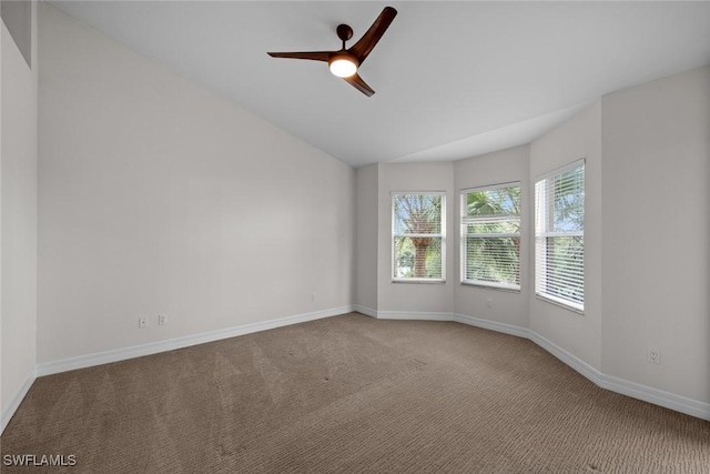 empty room with light carpet, lofted ceiling, and ceiling fan