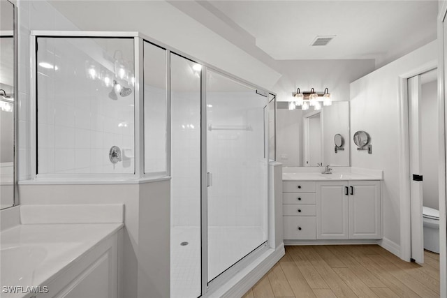 bathroom featuring vanity, hardwood / wood-style floors, and a shower with shower door