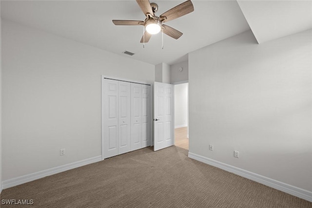 unfurnished bedroom featuring carpet floors, ceiling fan, and a closet