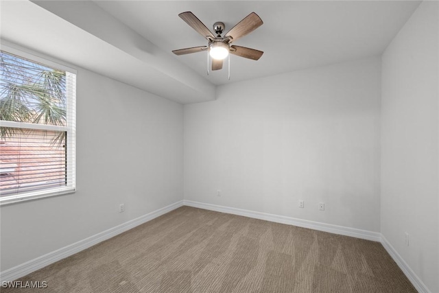 carpeted empty room featuring ceiling fan