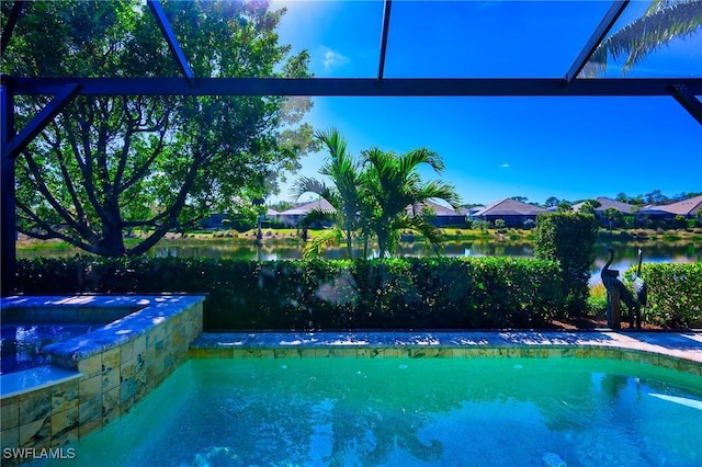 view of swimming pool featuring a water view and glass enclosure