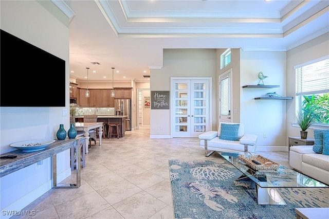 living room with light tile patterned floors, crown molding, a raised ceiling, and a healthy amount of sunlight