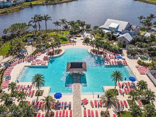 view of swimming pool with a water view and a patio area