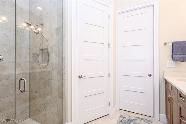 bathroom with vanity, tile patterned floors, and a shower with shower door