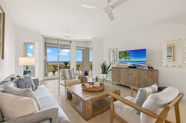 living room with expansive windows, light tile patterned floors, and ceiling fan