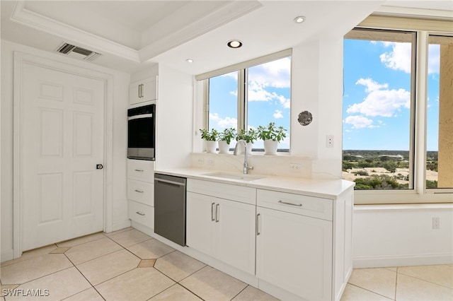 kitchen with oven, sink, stainless steel dishwasher, and white cabinets