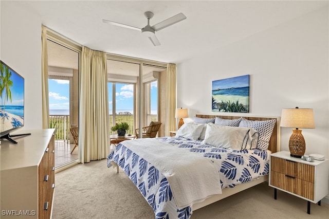 bedroom with access to outside, light colored carpet, ceiling fan, and a wall of windows