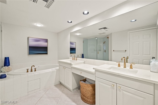 bathroom with vanity, tile patterned flooring, and plus walk in shower