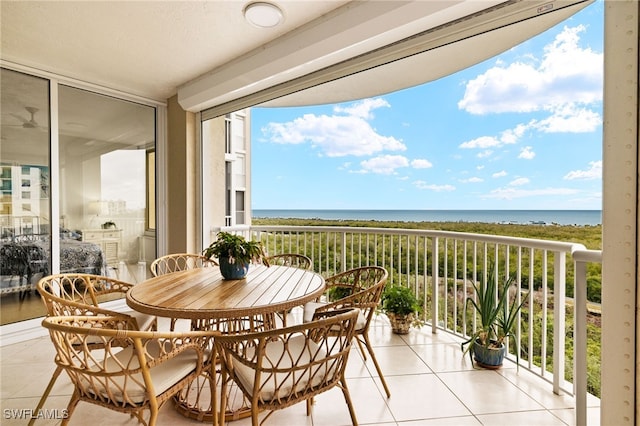 balcony with a water view and a beach view