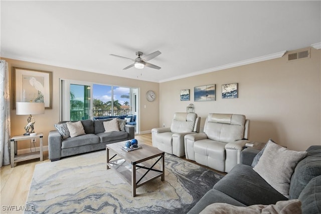 living room featuring ceiling fan, ornamental molding, and light hardwood / wood-style floors