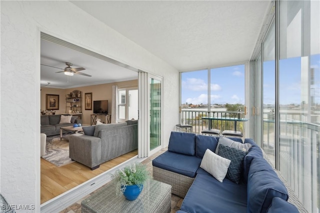 sunroom / solarium featuring ceiling fan