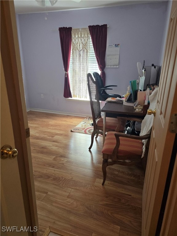 office with a ceiling fan, wood finished floors, and baseboards