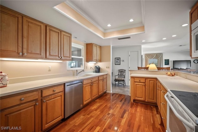 kitchen featuring wood-type flooring, white electric range oven, stainless steel dishwasher, a raised ceiling, and crown molding