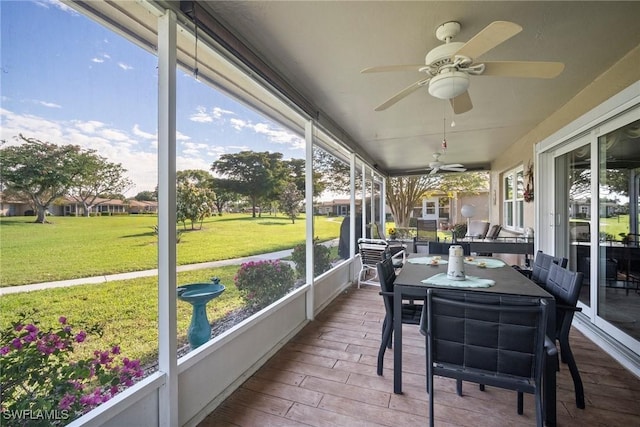 sunroom / solarium featuring ceiling fan