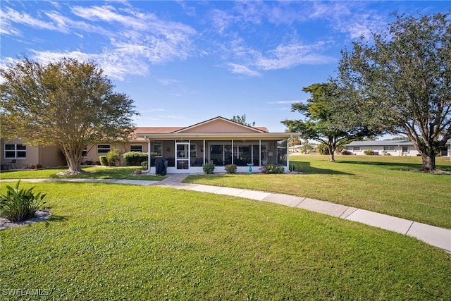 ranch-style house featuring a front lawn and a sunroom