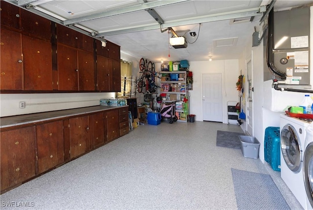 garage featuring a garage door opener and separate washer and dryer