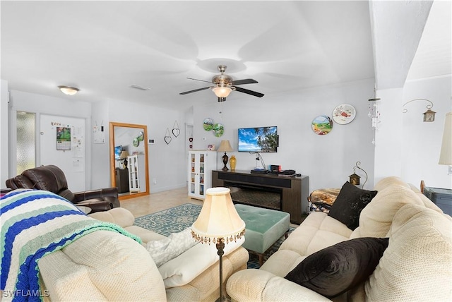 living room featuring ceiling fan and tile patterned flooring