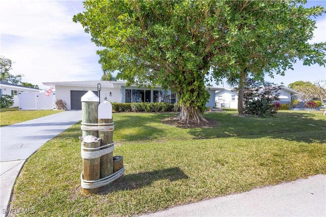 view of front of house with a garage and a front yard