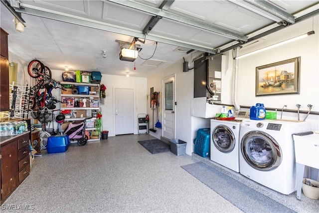 garage featuring independent washer and dryer and a garage door opener