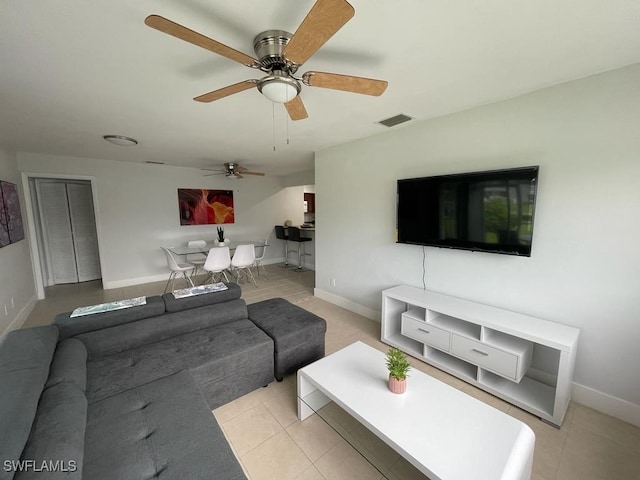 living room featuring light tile patterned flooring and ceiling fan