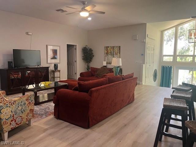 living room with ceiling fan and light hardwood / wood-style floors