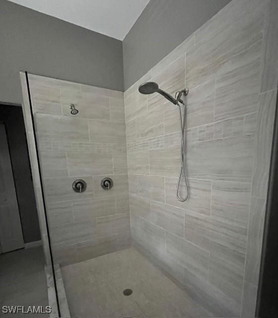 bathroom with a tile shower