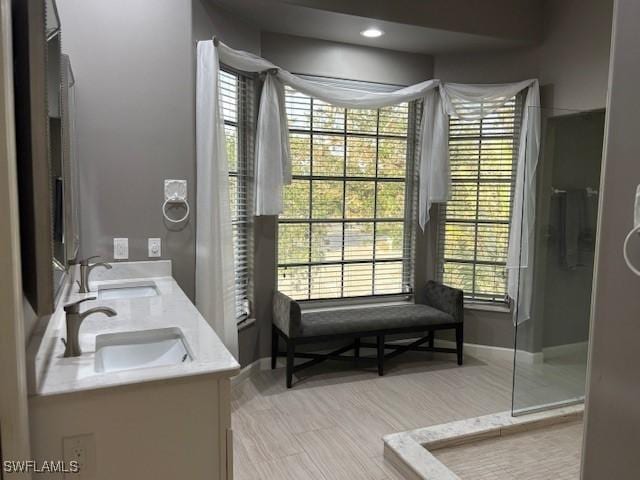 bathroom featuring vanity and a shower