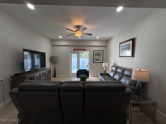 carpeted living room with ceiling fan