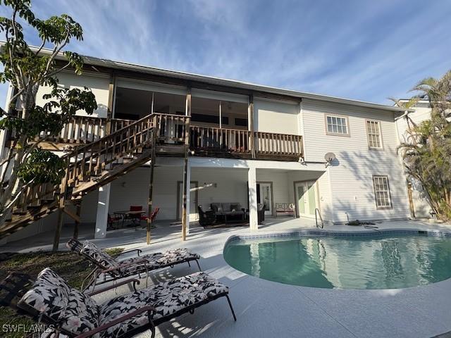 rear view of property featuring a balcony and a patio area