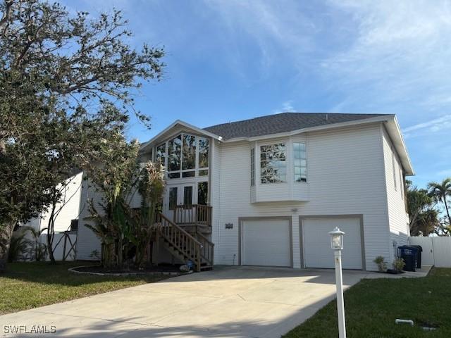 view of front of property with a garage and a front lawn