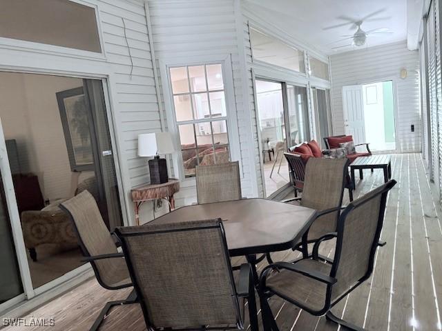 sunroom / solarium featuring ceiling fan