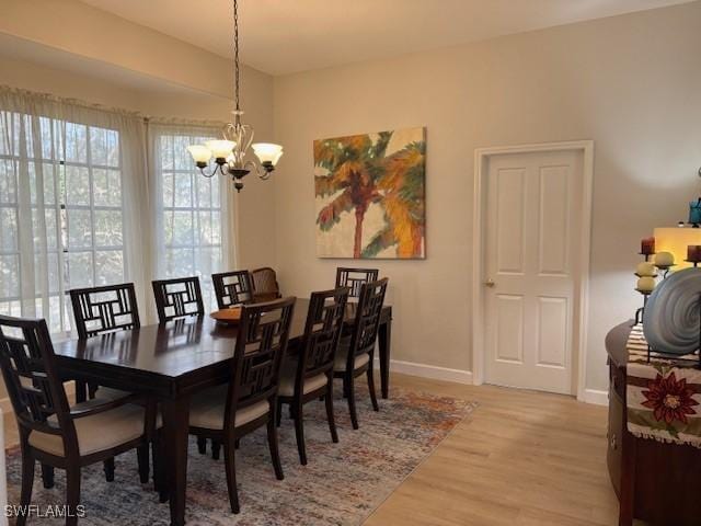 dining area featuring a chandelier and light hardwood / wood-style flooring