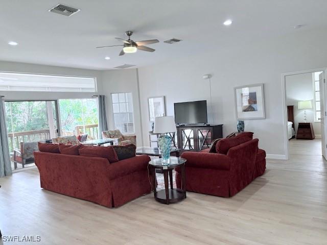 living room featuring ceiling fan and light wood-type flooring