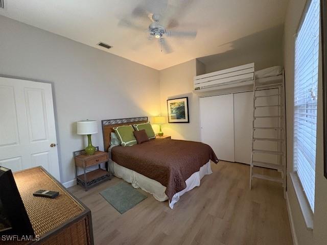 bedroom with ceiling fan, a closet, and light wood-type flooring