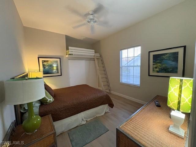 bedroom with ceiling fan and light hardwood / wood-style flooring