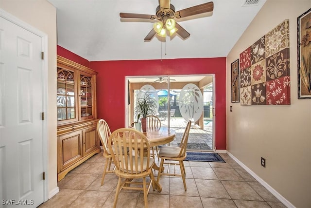 dining space featuring light tile patterned flooring, ceiling fan, and lofted ceiling