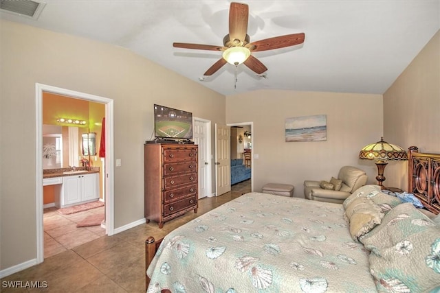 tiled bedroom with ceiling fan, ensuite bath, sink, and vaulted ceiling