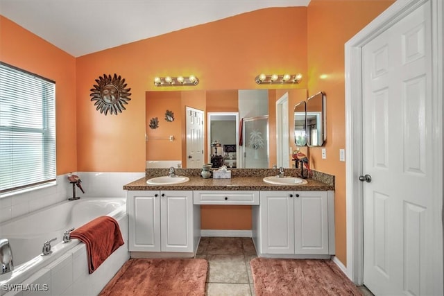 bathroom featuring tile patterned flooring, vanity, vaulted ceiling, and independent shower and bath