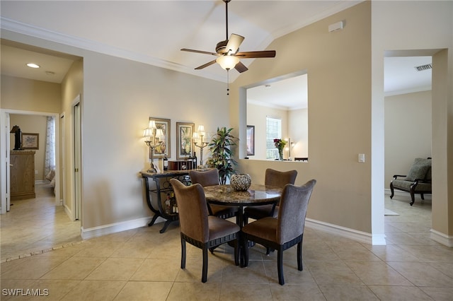 dining space with light tile patterned floors, crown molding, and ceiling fan