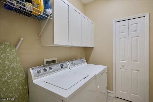 laundry area featuring washer and dryer and light tile patterned floors