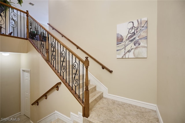 staircase featuring tile patterned flooring