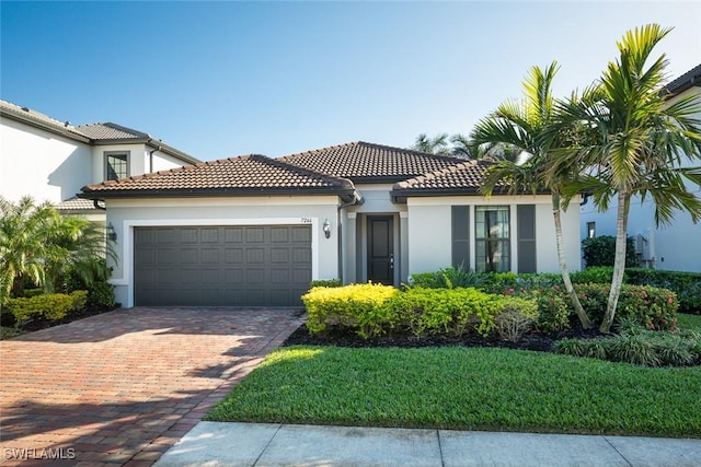 mediterranean / spanish-style house with a garage